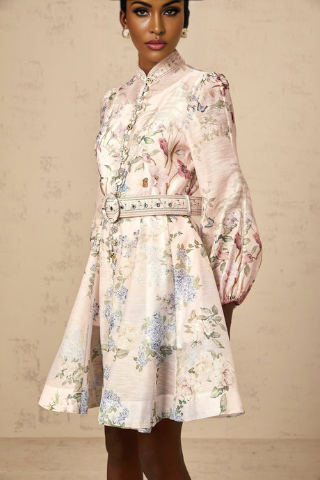 A light pink mini dress with a floral print pattern covering the fabric