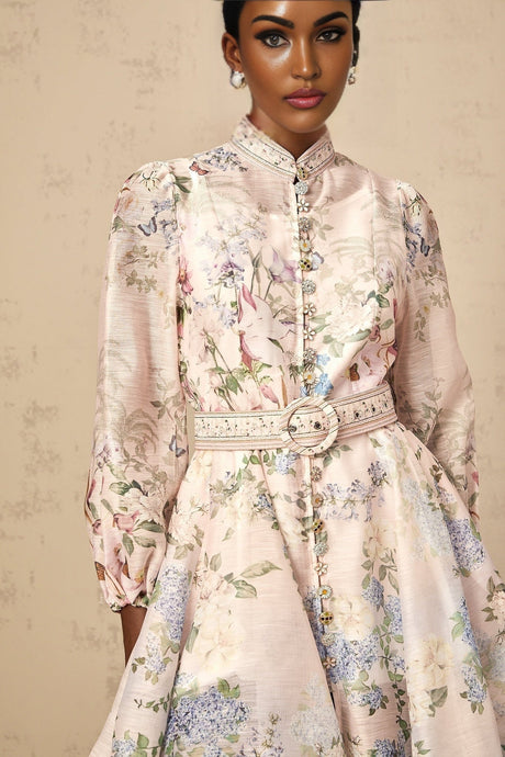 A light pink mini dress with a floral print pattern covering the fabric
