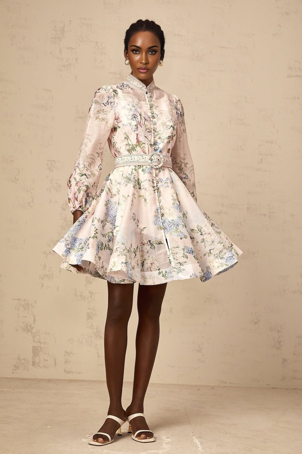 A light pink mini dress with a floral print pattern covering the fabric