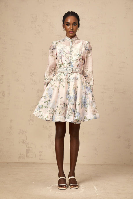 A light pink mini dress with a floral print pattern featuring short sleeves and a fitted silhouette