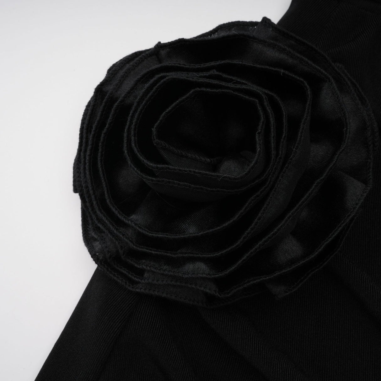 A long black hooded maxi dress with floral applique detailing named Axelle