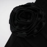 A long black hooded maxi dress with floral applique detailing named Axelle