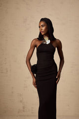 A long black hooded maxi dress with floral applique details on the fabric