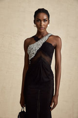 A long black maxi dress with a crossover bodice adorned with crystal embellishments featuring a flowing skirt and elegant silhouette