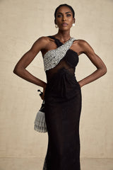 A long black maxi dress with a crossover bodice featuring crystal embellishments and a flowing skirt