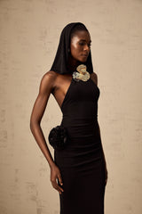 A long black maxi dress with a hood featuring floral appliques on the bodice