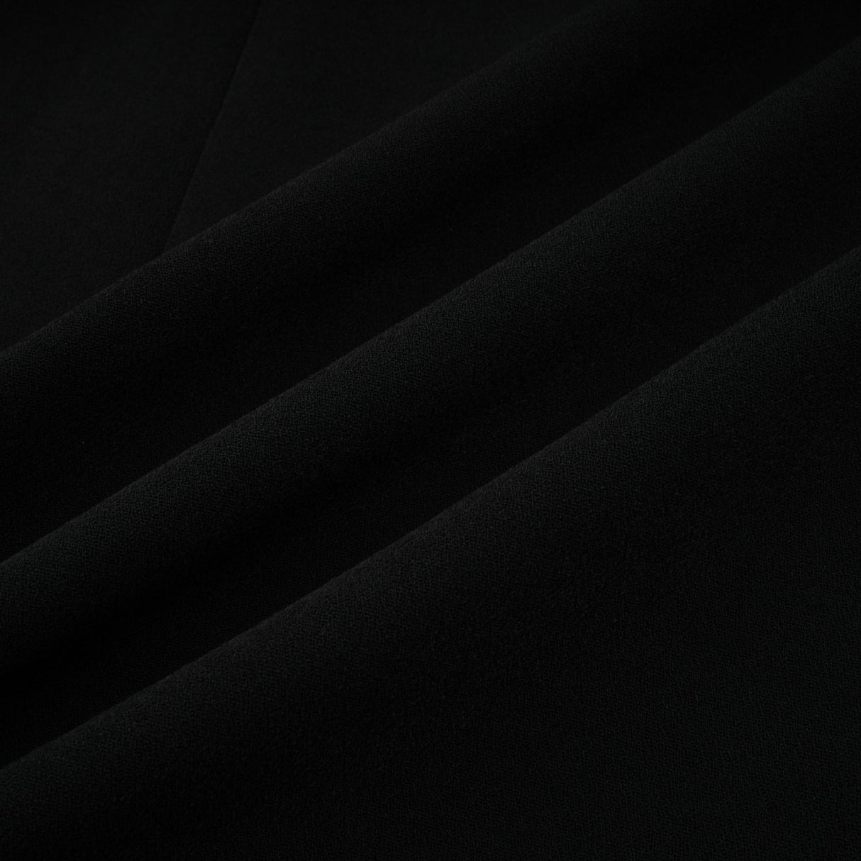 A long black maxi dress with blazer style top featuring embellishments and a feminine silhouette