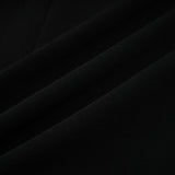 A long black maxi dress with blazer style top featuring embellishments and a feminine silhouette