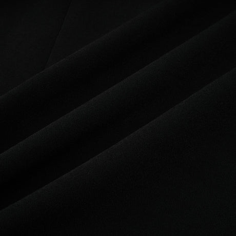 A long black maxi dress with blazer style top featuring embellishments and a feminine silhouette