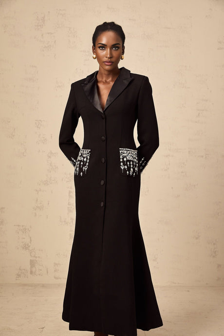 A long black maxi dress with blazer styling featuring embellished details and a feminine silhouette