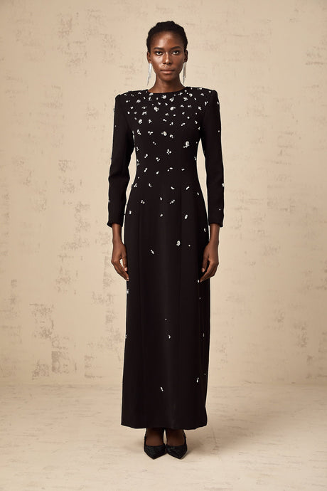 A long black maxi dress with crystal embellishments adorning the fabric elegant evening gown with sparkling details