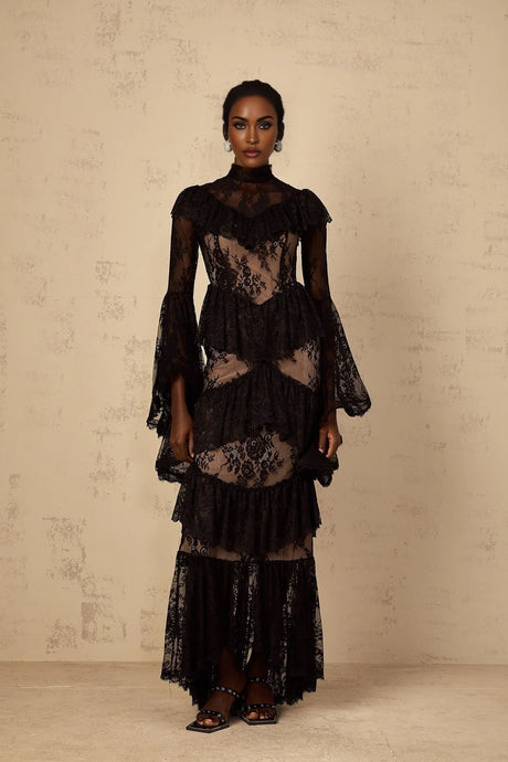 A long black maxi dress with floral lace pattern and ruffled details featuring a feminine silhouette
