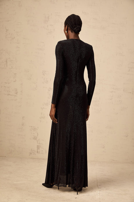 A long black maxi dress with ruched mesh fabric and rhinestone embellishments