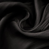 A long black pleated satin maxi dress with a flowing silhouette named Mila