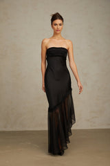 A long black satin maxi dress with sheer tulle panels featuring a sleek silhouette and elegant design