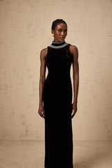 A long black velvet gown with crystal embellishments on a mannequin or model against a plain background