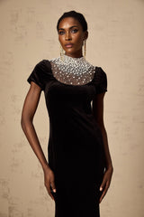 A long black velvet maxi dress adorned with faux pearl embellishments named Kristin