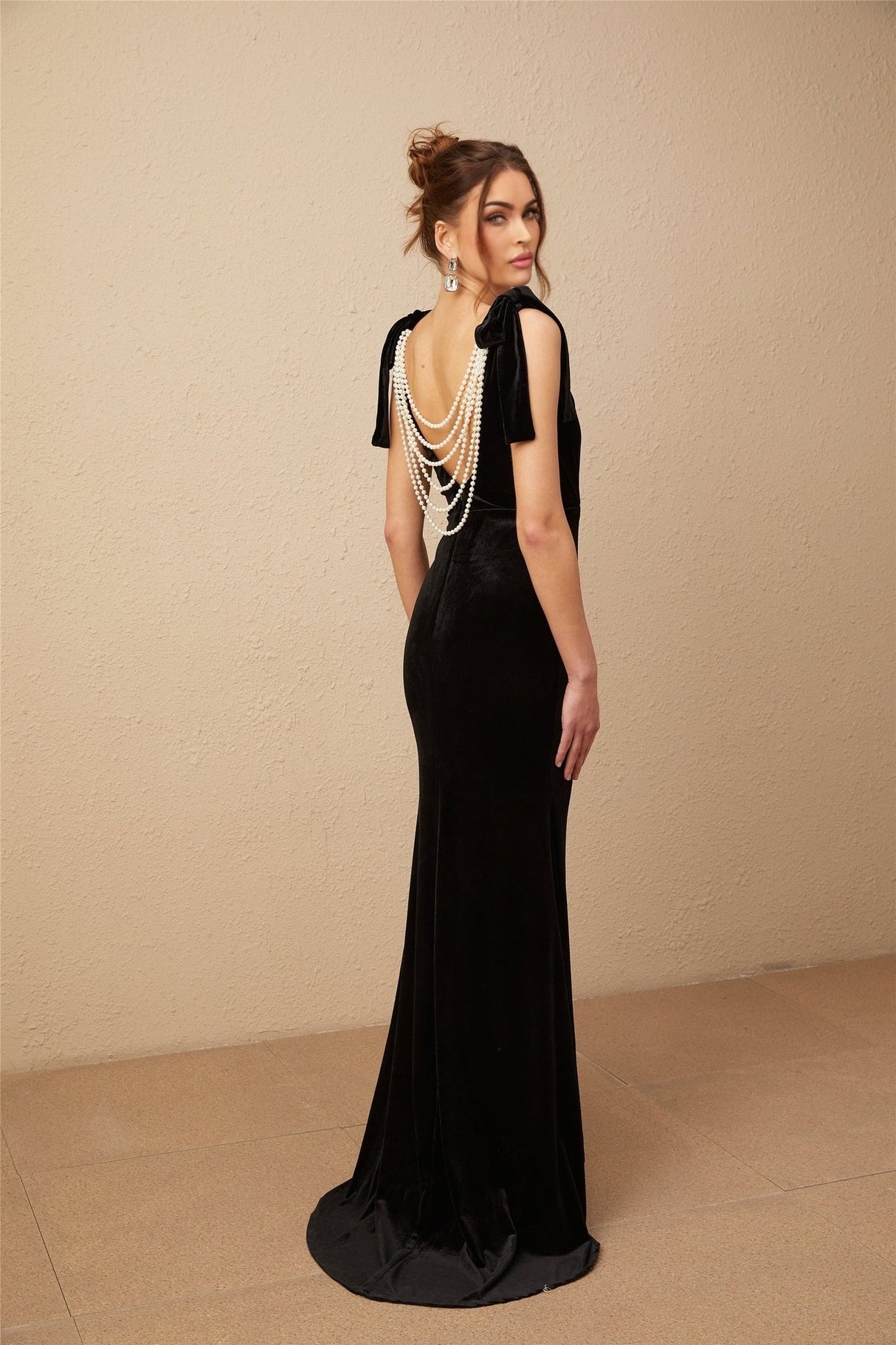 A long black velvet maxi dress with an open back and embellished details named Audrey