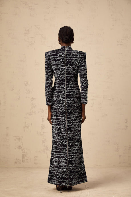 A long black velvet maxi dress with jade colored letter print design