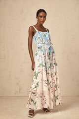 A long blue maxi dress with a floral print pattern and pleated design