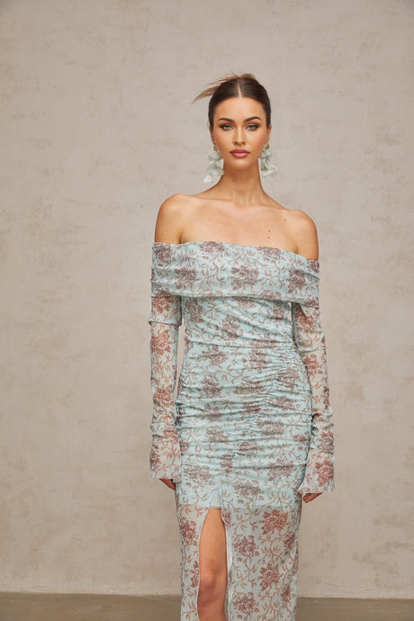 A long blue maxi dress with a floral print pattern and ruched details