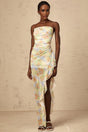 A long blue maxi dress with an asymmetric design featuring a floral print pattern and ruched detailing