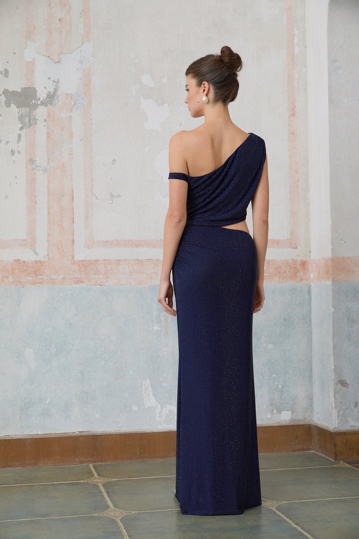 A long blue maxi dress with cut out details and rhinestone embellishments