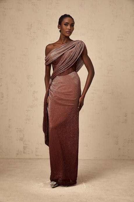 A long brown maxi dress with a corsetstyle top featuring ribbon design details and a flowing skirt
