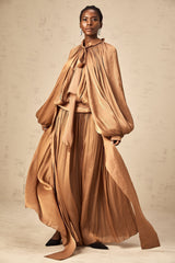 A long brown pleated satin maxi dress with a flowing silhouette