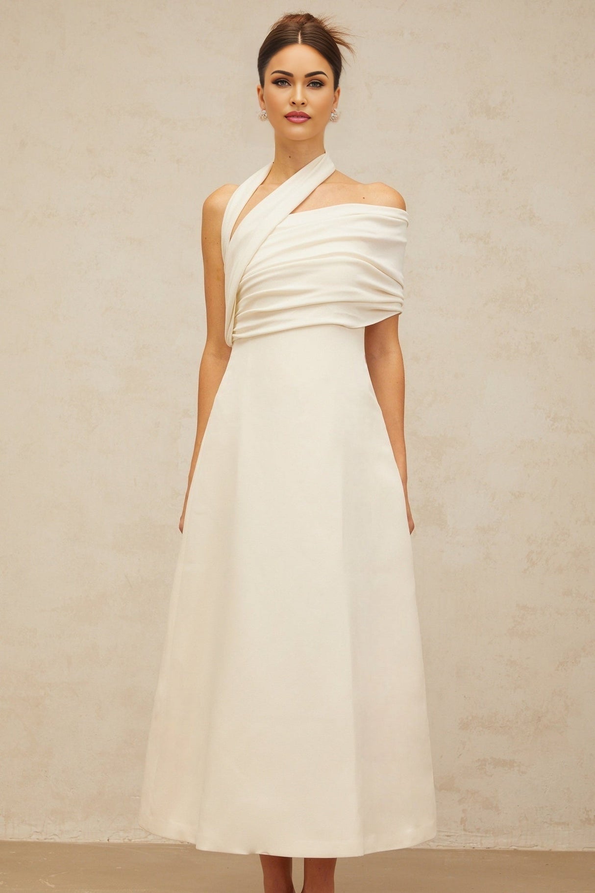 A long creamwhite maxi dress with an asymmetric design featuring a Solene label