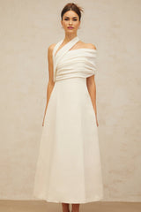 A long creamwhite maxi dress with an asymmetric design featuring a Solene label