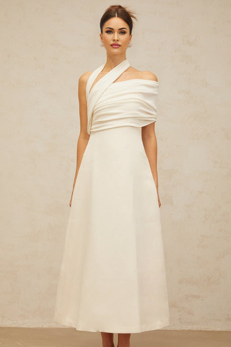 A long creamwhite maxi dress with an asymmetric design featuring a Solene label