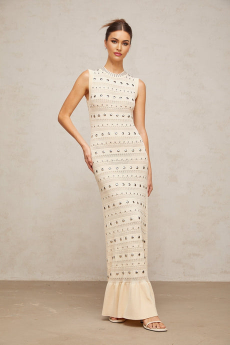 A long crochet knit maxi dress in neutral tones with studded detailing by Chloe