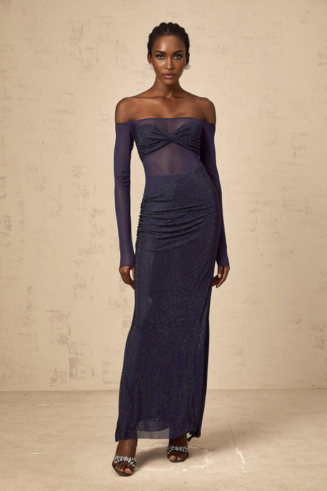A long dark blue maxi dress with a corsetstyle bodice featuring sheer tulle panels and embellished details
