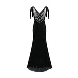 A long dark velvet dress with an open back and embellished details named Audrey shown on a model