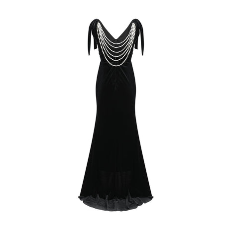 A long dark velvet dress with an open back and embellished details named Audrey shown on a model