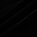 A long dark velvet dress with an open back and embellishments named Audrey shown on a model against a plain background