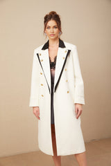 A long doublebreasted blazer featuring color blocks in different shades of wool fabric with a terracotta or earth tone color scheme