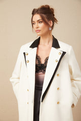 A long doublebreasted blazer made of wool featuring color blocking in shades of terracotta and beige with contrasting lapels and pockets