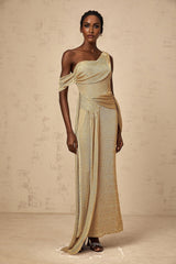 A long elegant gold maxi dress with ribbon design details and gathered fabric featuring a flowy silhouette