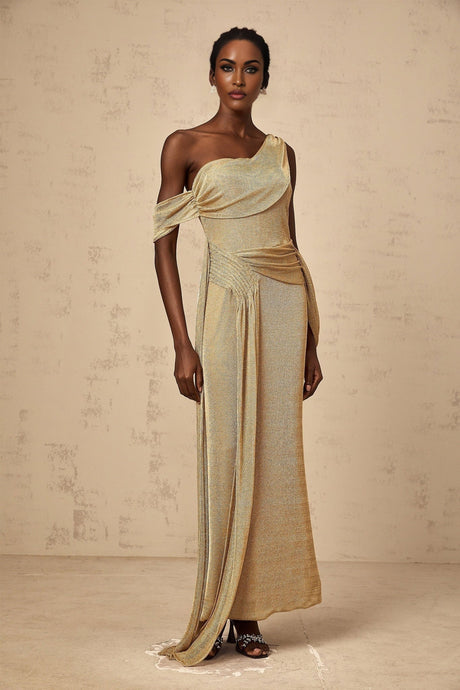 A long elegant gold maxi dress with ribbon design details and gathered fabric featuring a flowy silhouette