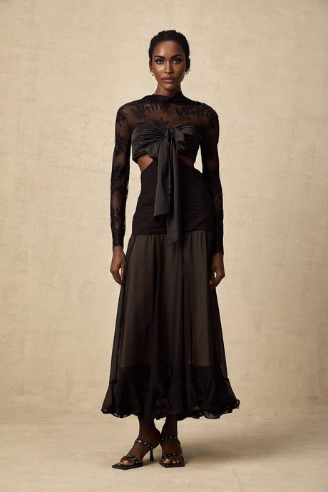 A long elegant maxi dress featuring floral lace panels and a flowing silhouette with a feminine design by Maiwenn