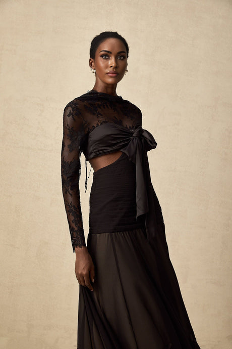 A long elegant maxi dress with floral lace panels and a feminine silhouette in a light color