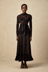 A long elegant maxi dress with floral lace panels featuring a delicate pattern throughout the garment The dress has a flowing silhouette and appears to be made of lightweight fabric suitable for formal or evening wear