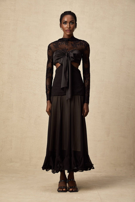 A long elegant maxi dress with floral lace panels featuring a delicate pattern throughout the garment The dress has a flowing silhouette and appears to be made of lightweight fabric suitable for formal or evening wear