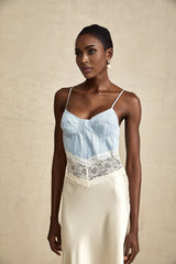 A long elegant maxi dress with lace trim and panels featuring a feminine silhouette in a flowing fabric