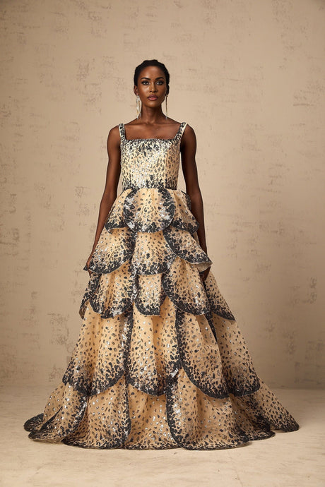 A long elegant maxi dress with tiered layers featuring shimmering sequin details and a delicate petal design throughout