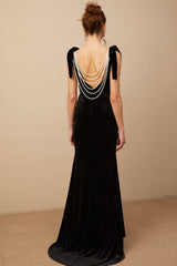 A long elegant velvet maxi dress in dark color with embellishments and an open back design named Audrey