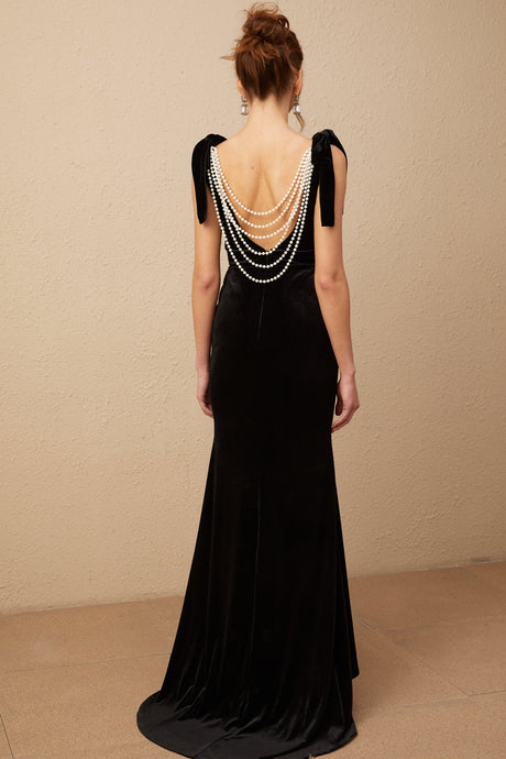 A long elegant velvet maxi dress in dark color with embellishments and an open back design named Audrey