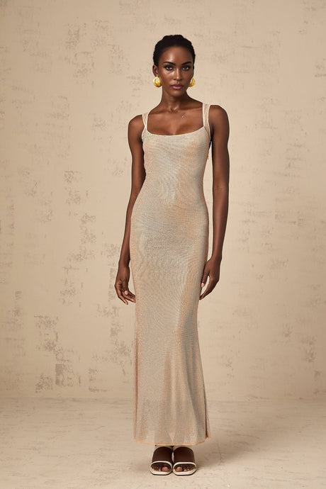 A long elegant white maxi dress with crystal embellishments and an open back design